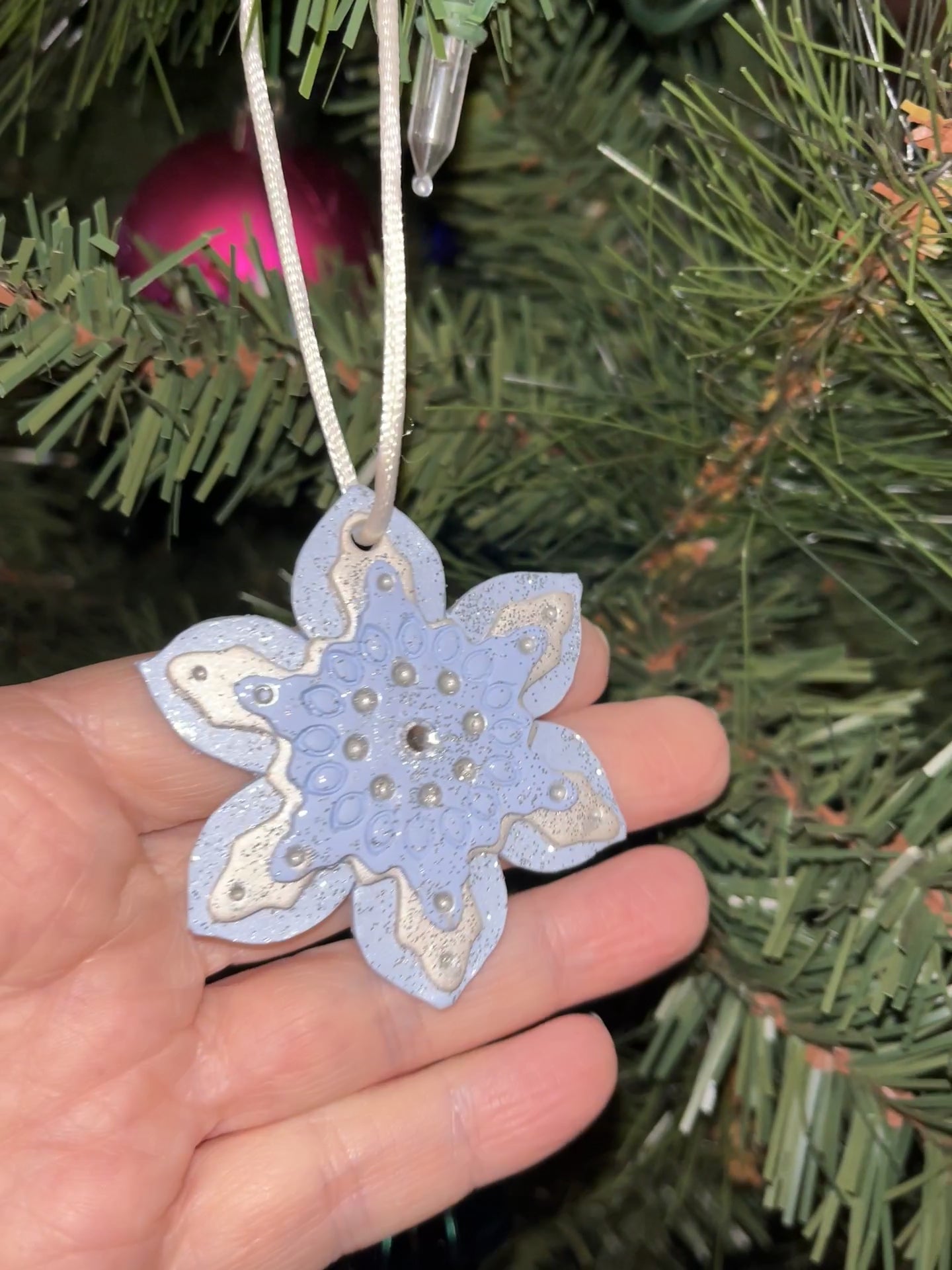 Three layers of snowflake, light blue, pearl, and pale blue with silver glitter.