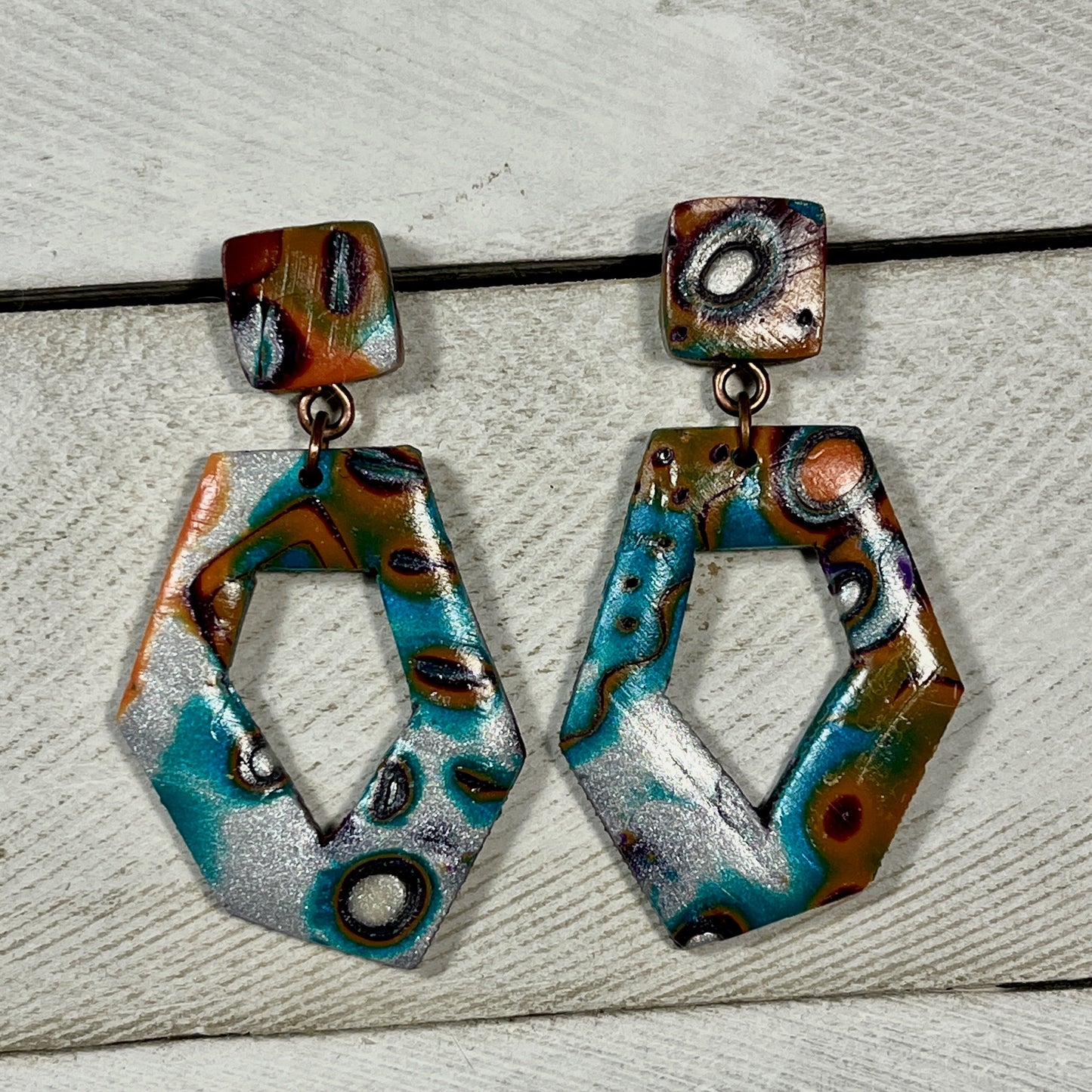 Purple, silver, teal and orange mokume gane skewed hexagon window with square posts